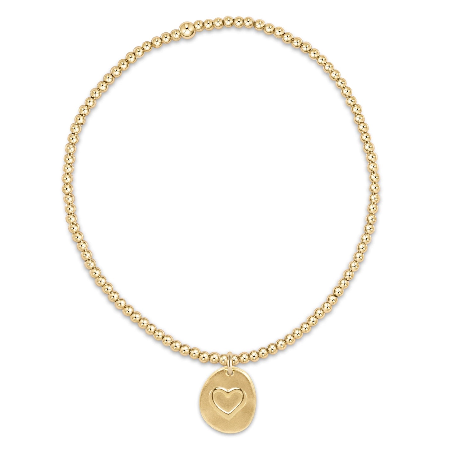 Gold bracelet with a heart-shaped charm on a white background