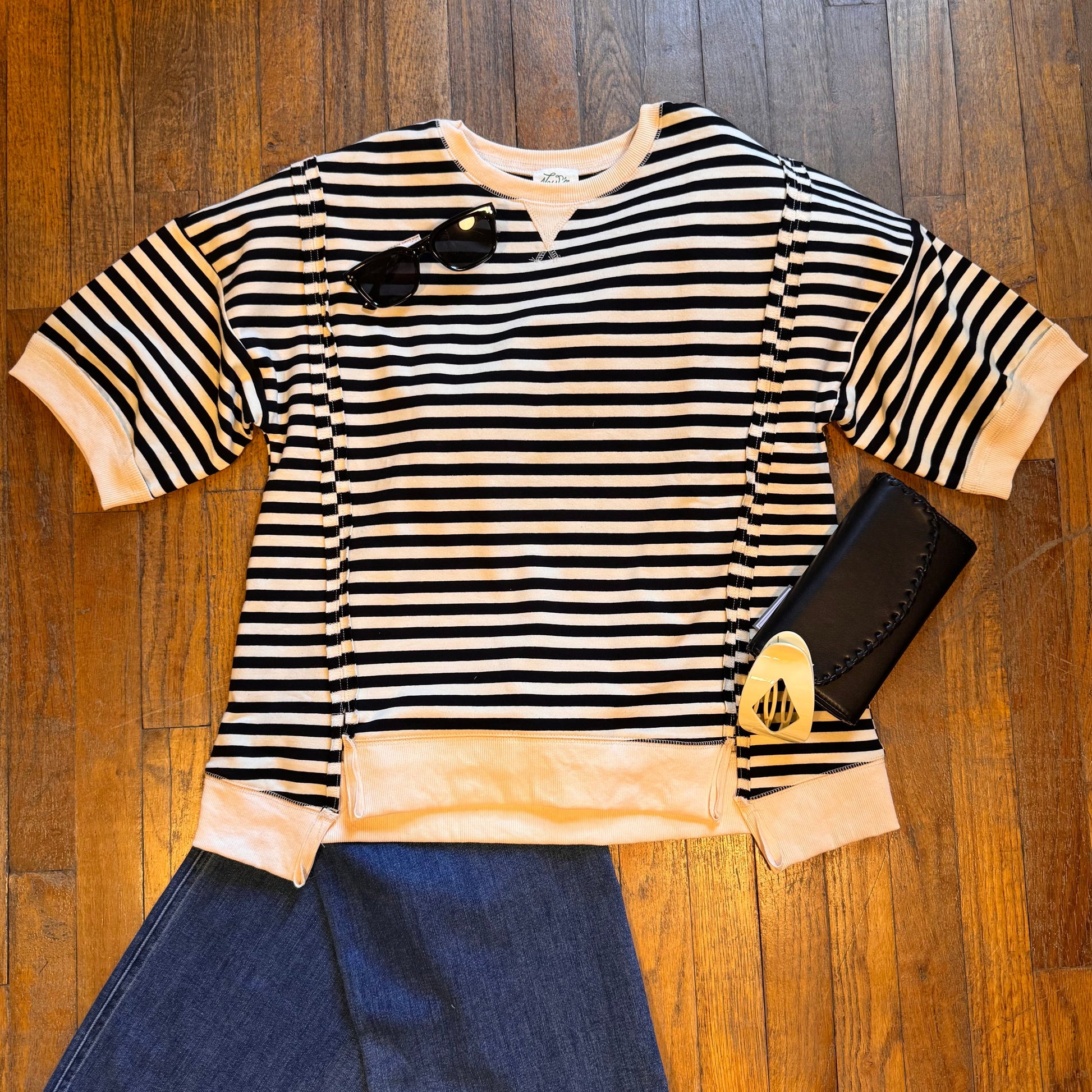 Striped shirt and jeans on a wooden floor