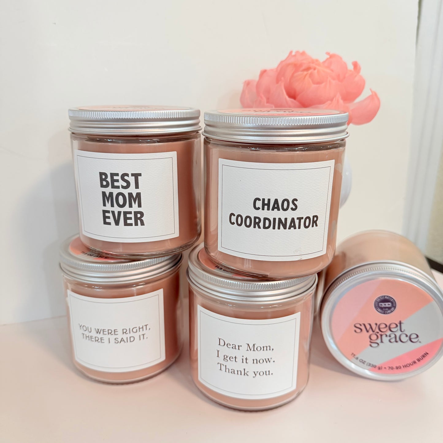 Set of candles with humorous labels on a white surface