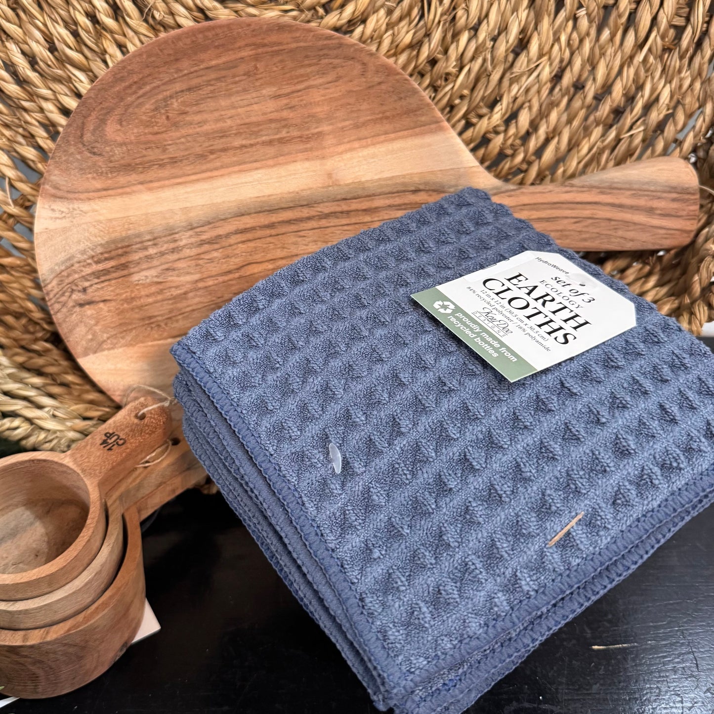 Blue cloth with a label on a woven surface with wooden items