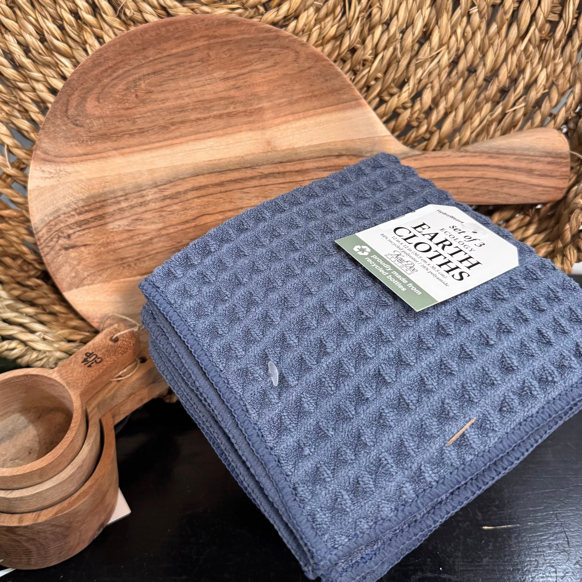 Blue cloth with a label on a woven surface with wooden items