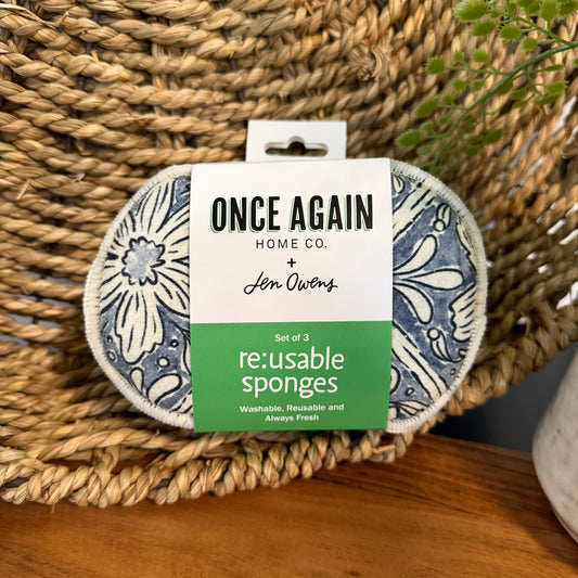 Pack of reusable sponges with floral design on a woven surface