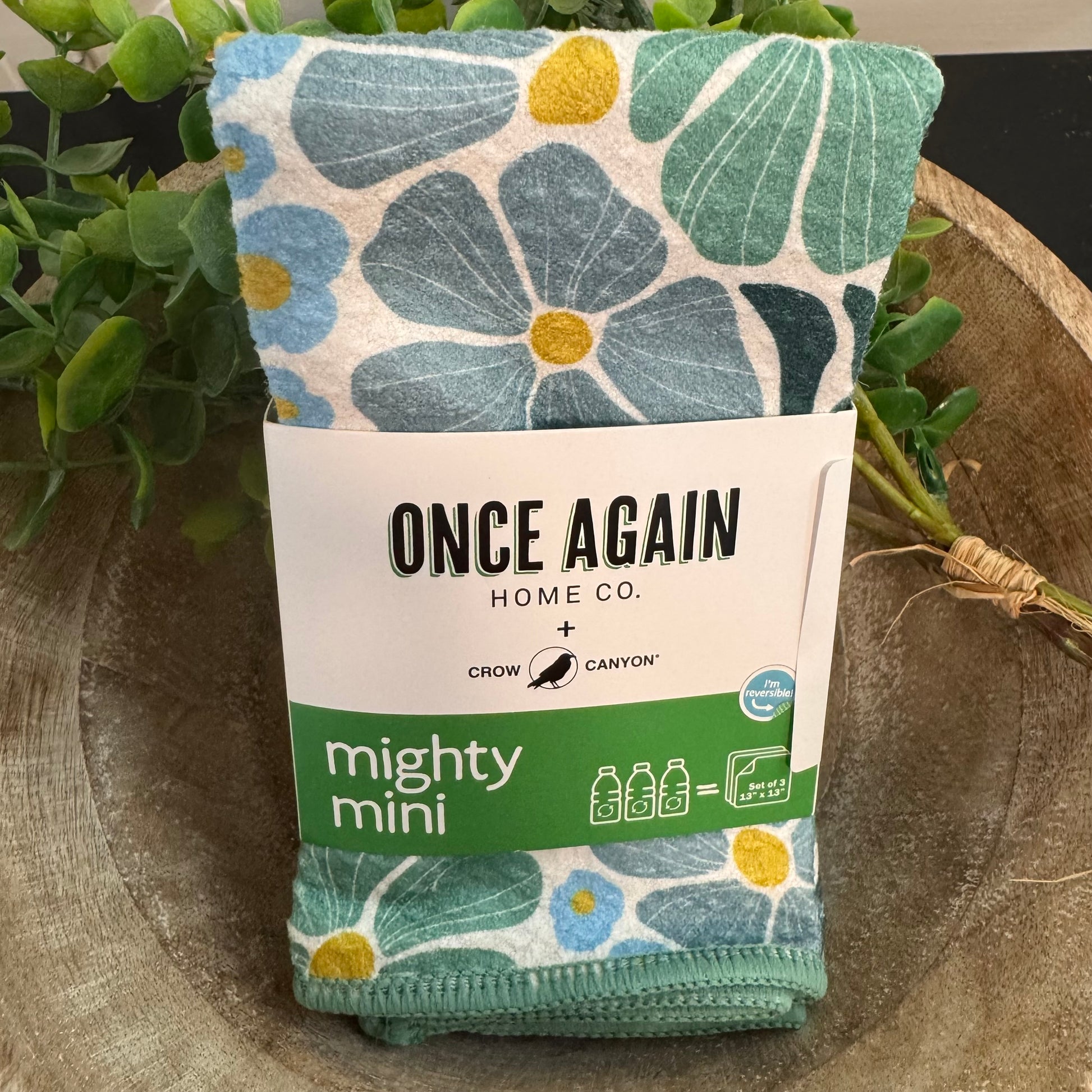 Floral-patterned product packaging with 'Once Again Home Co.' label on a natural background