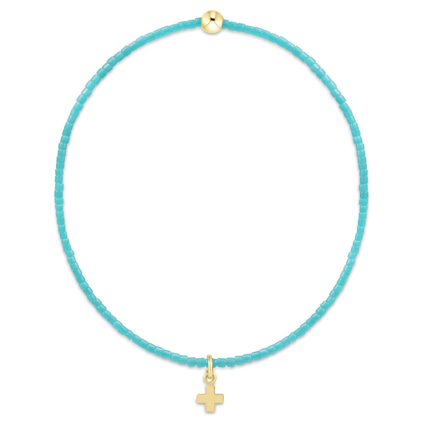 Turquoise cord necklace with gold cross pendant on a white background