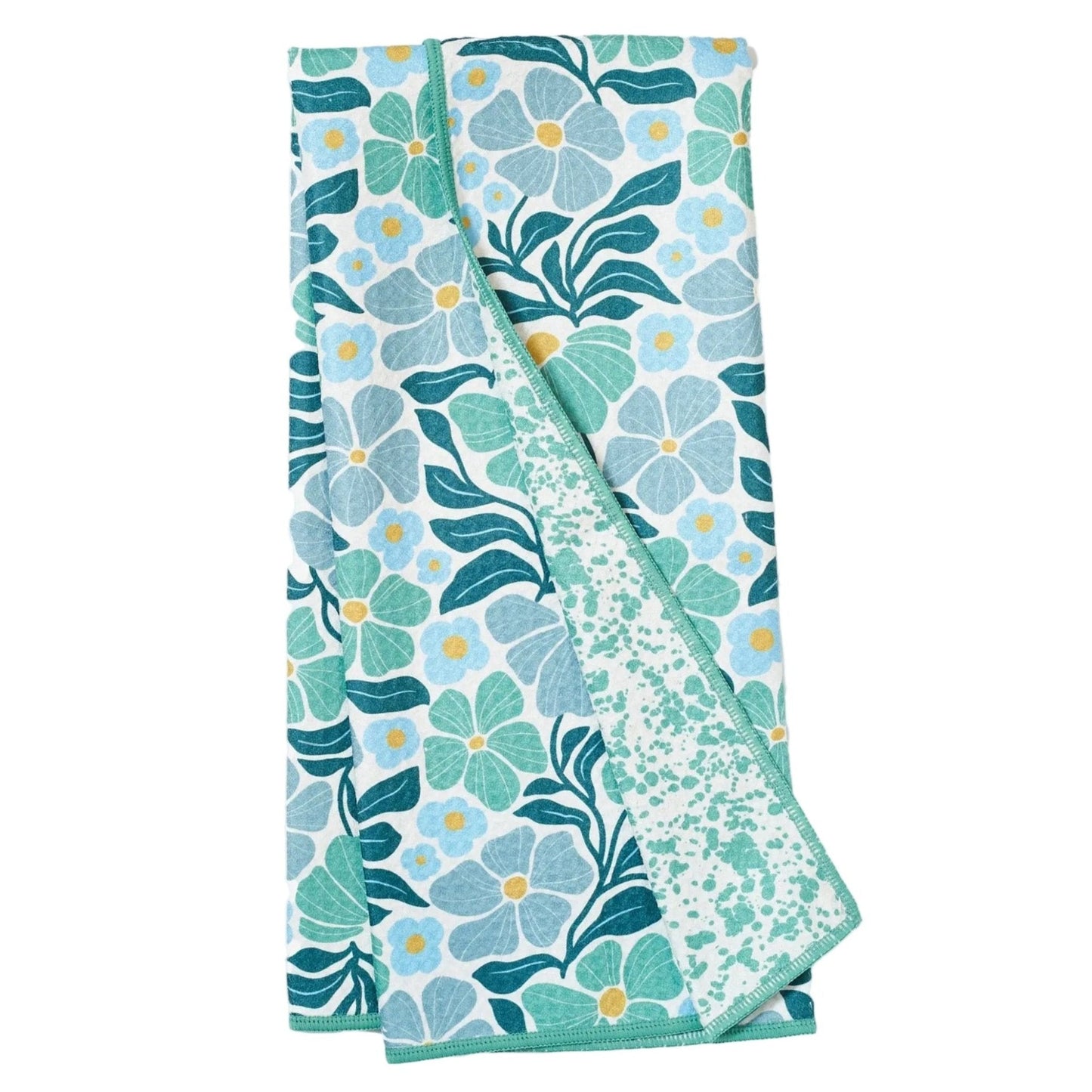 Folded floral towel with blue and green pattern on a white background
