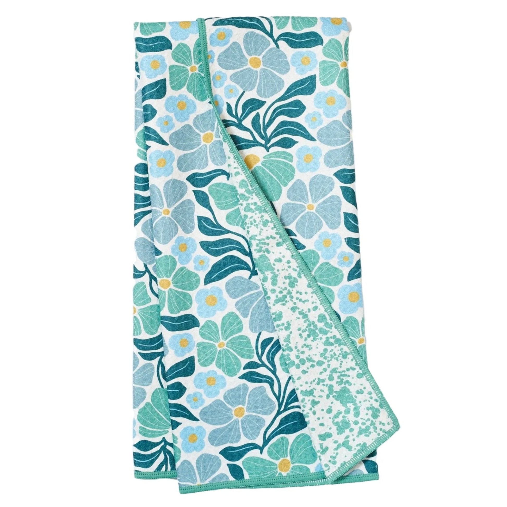 Folded floral towel with blue and green pattern on a white background
